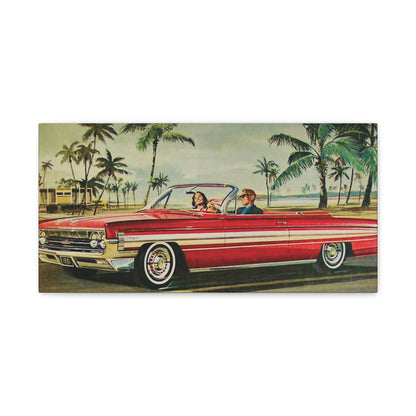  Panoramic view of a red vintage convertible car driving along a coastal road lined with palm trees.