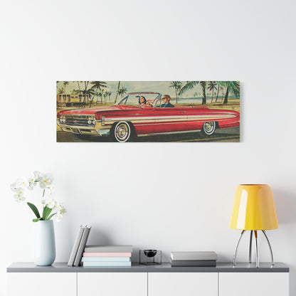  Panoramic view of a red vintage convertible car driving along a coastal road lined with palm trees.