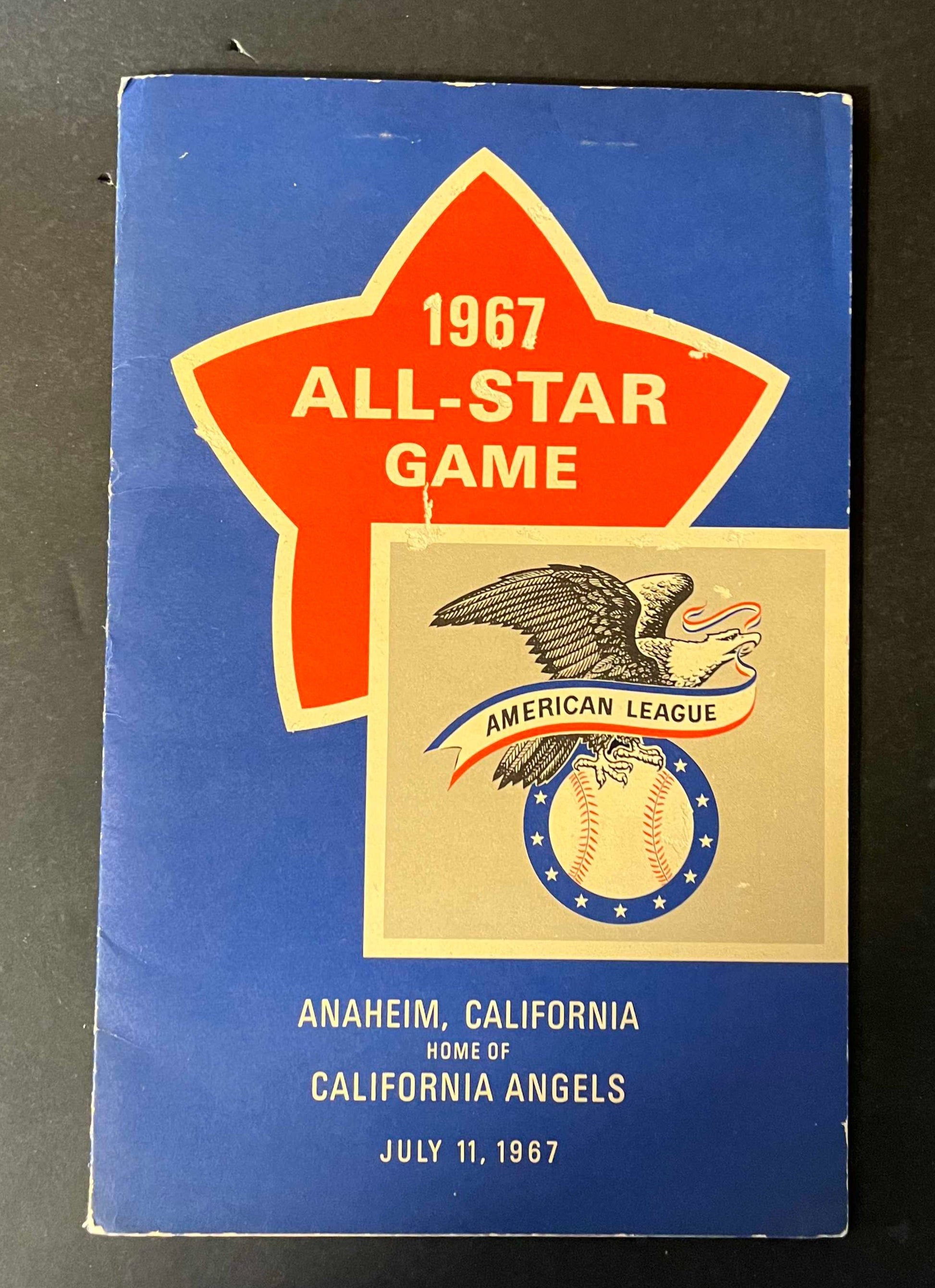 The cover proudly displays the All-Star Game logo with a classic design, highlighting the American League emblem and the date, set against a striking blue background. It’s a symbol of the celebration and competition that the All-Star Game represents.