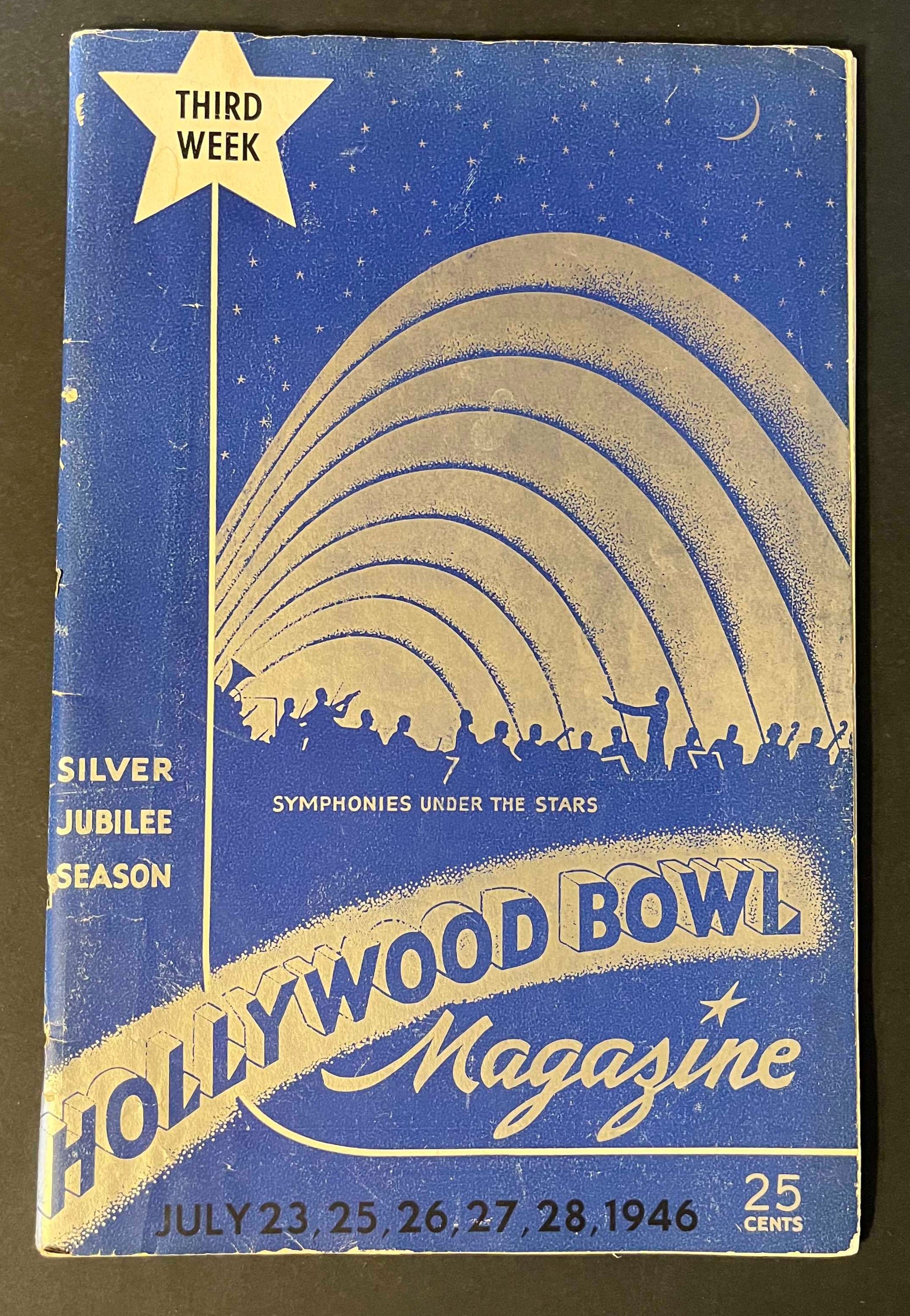 The magazine's cover art is a beautiful nocturnal scene, with stars twinkling above the Hollywood Bowl, capturing the magic of open-air concerts. The image is an invitation to relive the enchanting evenings of music and starlight that define the Hollywood Bowl experience.