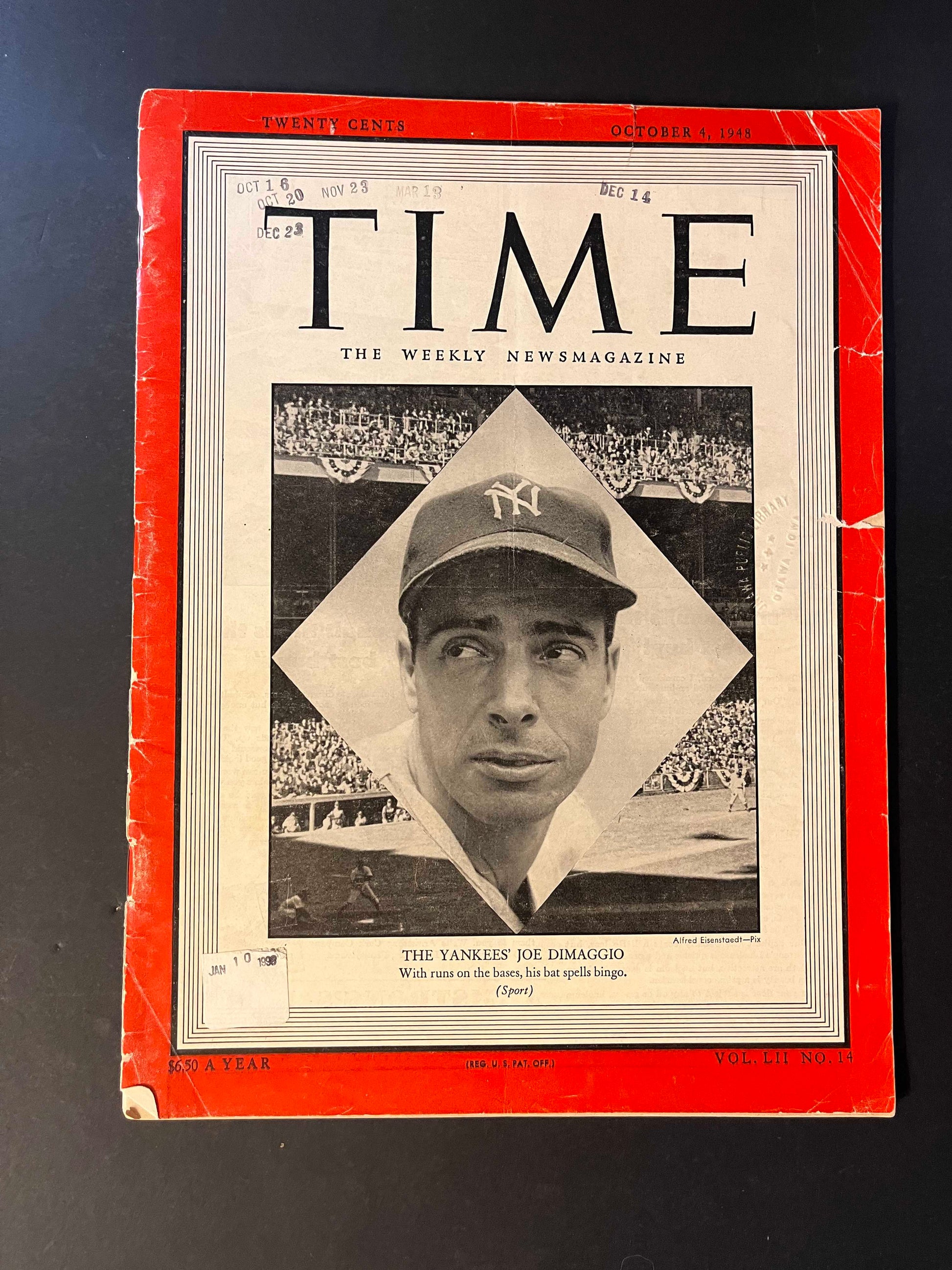 The black-and-white cover photo depicts Joe DiMaggio in a Yankees cap, set against the backdrop of a packed stadium, symbolizing his prominent stature in the baseball world and his impact on the sport.