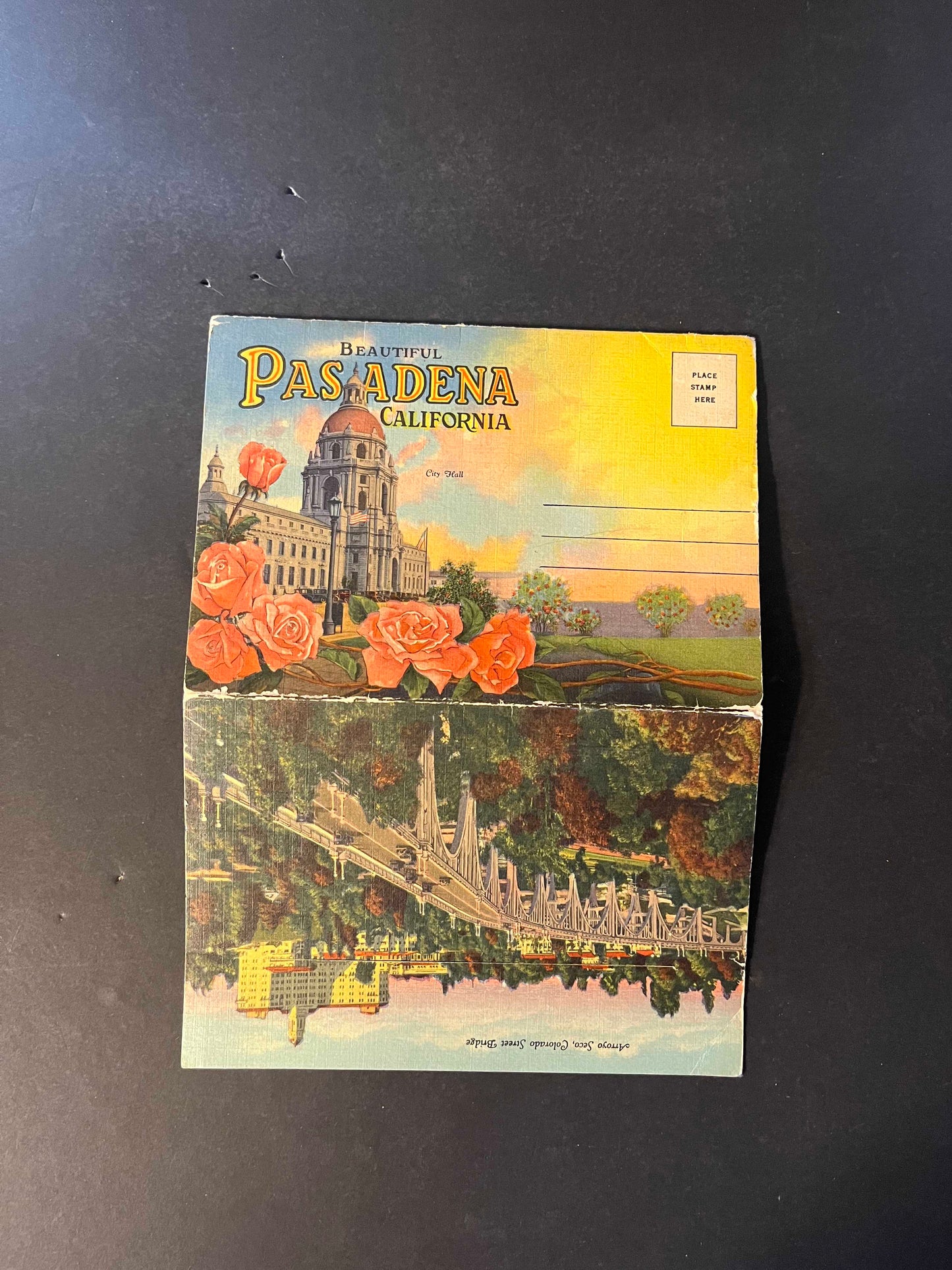 The folder showcases vivid depictions of Pasadena’s attractions, such as the iconic Colorado Street Bridge and the lush grounds of the Los Angeles Turf Club. It unfolds to reveal a treasure trove of hand-picked images that paint a picture of the city's allure in the 1940s.