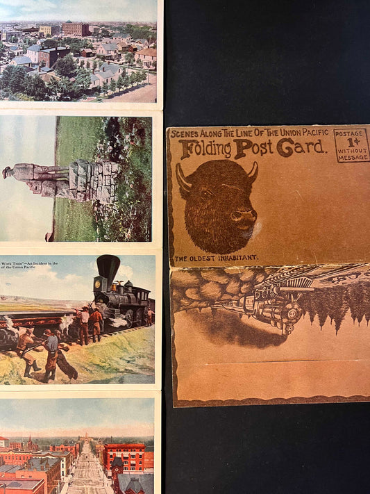 Each panel of the postcard depicts a different scene, from the dramatic rock formations of Utah's landscapes to the impressive locomotives and infrastructure that powered America's growth. The "oldest inhabitant" buffalo illustration evokes the rich wildlife heritage of the West.