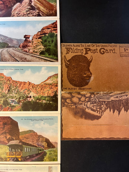 Each panel of the postcard depicts a different scene, from the dramatic rock formations of Utah's landscapes to the impressive locomotives and infrastructure that powered America's growth. The "oldest inhabitant" buffalo illustration evokes the rich wildlife heritage of the West.